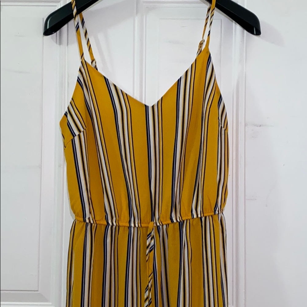 This is a yellow stripped jumper in a size small.